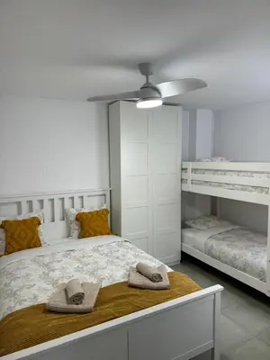 a bedroom with a bed with two bunk beds at UIM Mediterraneo Cendoya 5 Wifi in Puerto de Sagunto