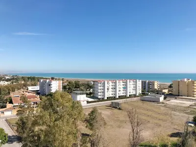 an aerial view of a city and the ocean at Global Vacacional, Moderno apartamento con piscina y terraza en la playa de Canet in Canet de Berenguer