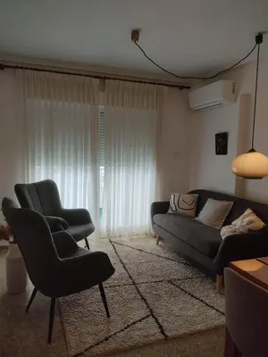 a living room with a couch and two chairs at Amanecer frente al mar in Valencia