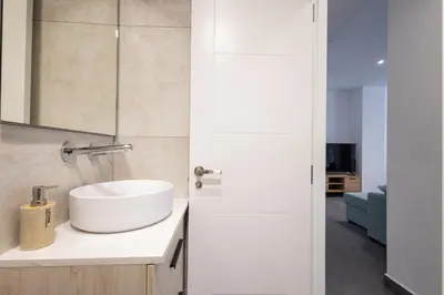 a bathroom with a sink and a mirror at FLORIT FLATS - The Patraix Apartments in Valencia