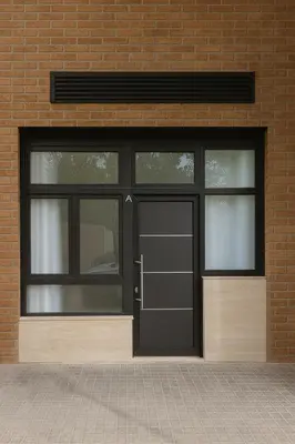 a black garage door with two windows on a brick building at APARTAMENTOS CIUDAD DE LAS ARTES Y LAS CIENCIAS in Valencia
