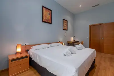 a bedroom with a large white bed with two pillows at Patacona Mediterranean Beach in Valencia