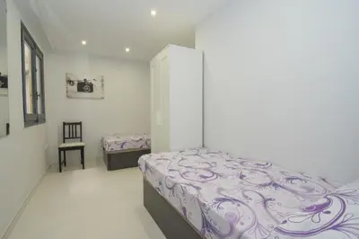 a bedroom with a bed and a chair in it at Calm Company in Valencia