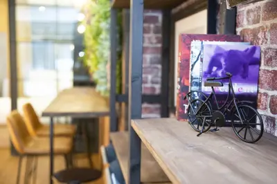 a bike sitting on a table next to a painting at Fabulosa vivienda nueva a un paso de Plaza EspañA in Valencia