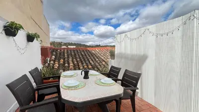 a table and chairs on a balcony with a view at La Casica de los Abuelos By El Conserje in Pedralba