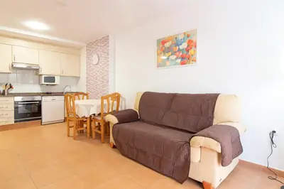 a living room with a couch and a table at Global Vacacional, Planta Baja con Piscina en Canet de Berenguer in Canet de Berenguer
