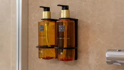 two bottles of oil hanging on a wall at Osito Hub - Pintor Nicolau in Valencia