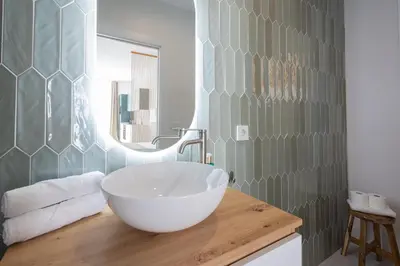 a bathroom with a large white bowl sink on a wooden counter at FLORIT FLATS - Stylish Studio by the Joaquin Sorolla Station in Valencia
