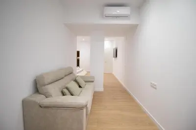 a living room with a couch and a hallway at BedTime Suites by Concept Flats in Valencia