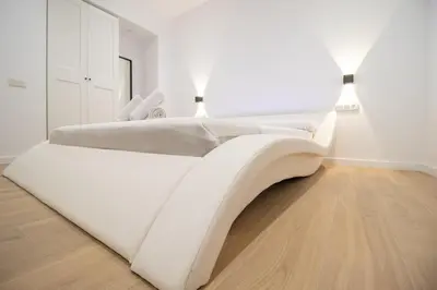 two beds in a white room with two lamps at BedTime Suites by Concept Flats in Valencia