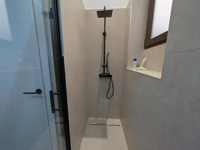 a room with a wooden floor and a table and a window at Las Arenas Suites 2 Playa in Valencia