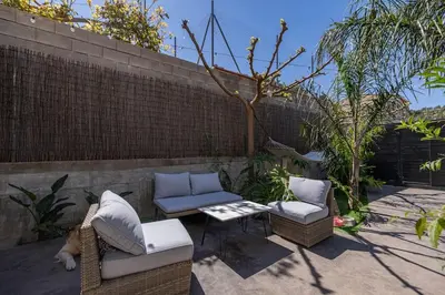a patio with two chairs and a table and a fence at Calm House, a 10 min playa de la de Cullera in Llaurí