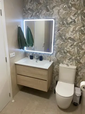 a bathroom with a sink and a toilet and a mirror at Mar&Sol Flats by Vivo GC in Valencia