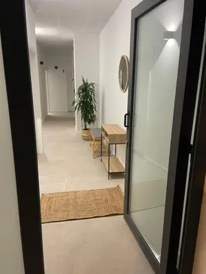 a glass door leading to a hallway with a table at Mar&Sol Flats by Vivo GC in Valencia
