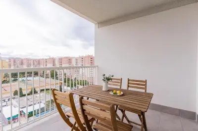 a dining room with a table and chairs and a balcony at Canet Seaview Gem: Pool & Beach Proximity in Canet de Berenguer