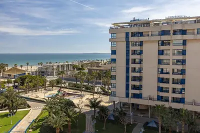 a view of a building and the beach at ApartUP Patacona Infinity in Valencia