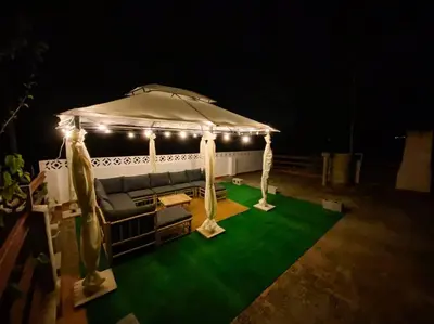 a white gazebo with a couch and lights at Villa Caliqueña, casa de campo in Torrent