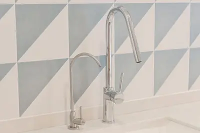 a kitchen sink with two faucets on a wall at Malvarrosa Beach Stay! in Valencia