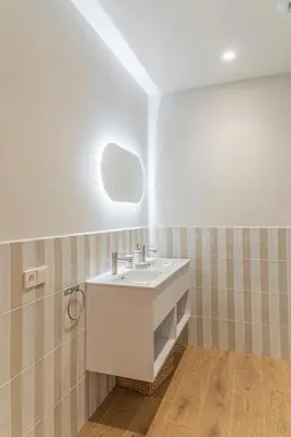 a bathroom with a white sink and a mirror at Malvarrosa Beach Stay! in Valencia