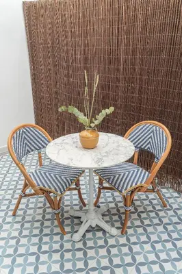 a table with a potted plant sitting between two chairs at Malvarrosa Beach Stay! in Valencia