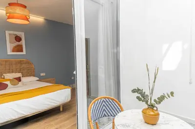 a bedroom with a bed and a table with a chair at Malvarrosa Beach Stay! in Valencia