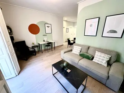 a living room with a couch and a table at Casa Únic - Modern Central Home in Ruzafa in Valencia