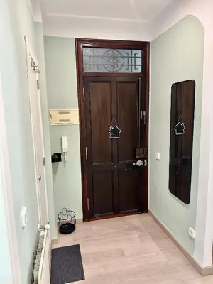a wooden door in a room with a hallway at Casa Únic - Modern Central Home in Ruzafa in Valencia