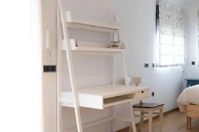 a ladder leaning against a desk in a room at Villa en Valencia, piscina privada y metro 500m in La Eliana