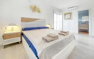 a bedroom with a large bed with towels on it at Gorgeous Home In Riba-Roja De Turia in Riba-Roja De Turia