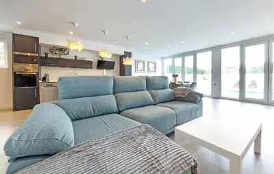 a large blue couch in a living room at Gorgeous Home In Riba-Roja De Turia in Riba-Roja De Turia
