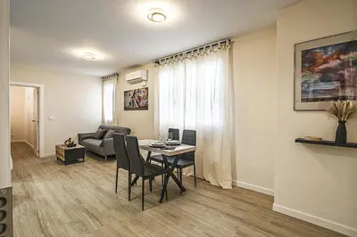 a living room with a table and a couch at PLAYA SUITES a 50 metros de la playa in Puerto de Sagunto