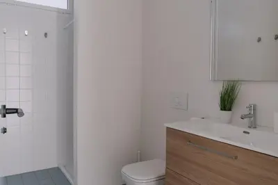 a white bathroom with a toilet and a sink at Coliving La Alfareria in Valencia