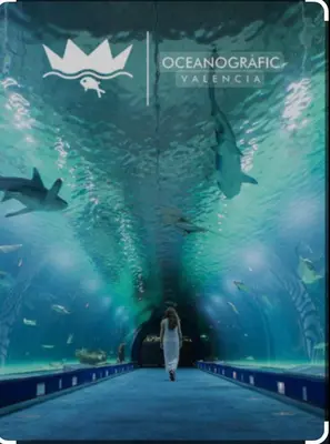 a woman walking through an aquarium with fish at Piso a 3 minutos de la playa!! 6 personas in Cullera