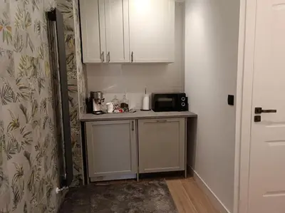 a small kitchen with a counter with a microwave at loft Gilet 20 km Valencia montaña Senderismo Bici in Gilet