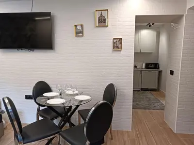 a dining room with a table and chairs and a flat screen tv at loft Gilet 20 km Valencia montaña Senderismo Bici in Gilet