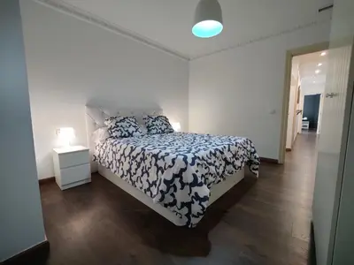 a bedroom with a bed with a blue and white comforter at Casona Torrent in Torrent