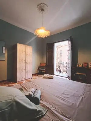 an empty room with a large bed and a window at Plaça de l'Almudí, where else! in Onda