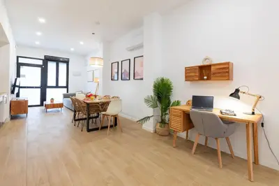 a living room with a desk and a dining room at Travel Habitat Zaidia con Terraza in Valencia