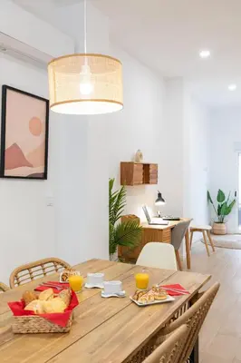 a dining room with a wooden table with food on it at Travel Habitat Zaidia con Terraza in Valencia