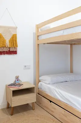 a bedroom with a bunk bed and a table with a night stand at Travel Habitat Zaidia con Terraza in Valencia