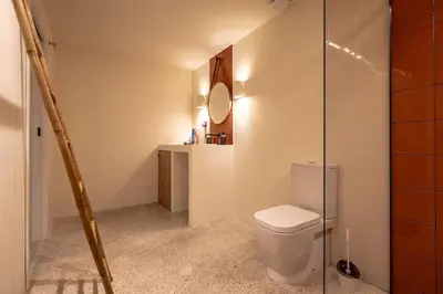 a bathroom with a toilet and a mirror at Suite de lujo estilo mediterráneo in Valencia