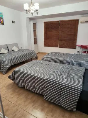 a bedroom with two beds and a couch at Valencia in Valencia