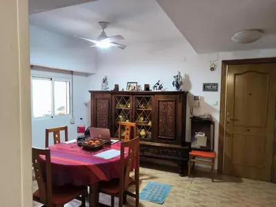 a dining room with a table and a cabinet at Valencia in Valencia