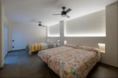 a bedroom with two beds and a ceiling fan at Céntrico 6 personas Ciencias Oceanografico in Valencia