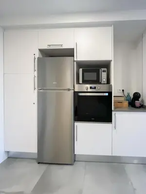 a kitchen with a refrigerator and a microwave at Diyenn Burriana alojamiento y placer in Burriana