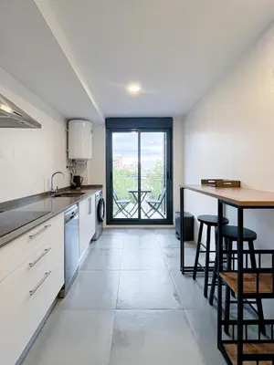 a kitchen with a table and chairs and a table at Diyenn Burriana alojamiento y placer in Burriana