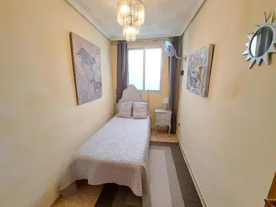 a small room with a bed and a window at Apartamento exterior de tres habitaciones in Valencia