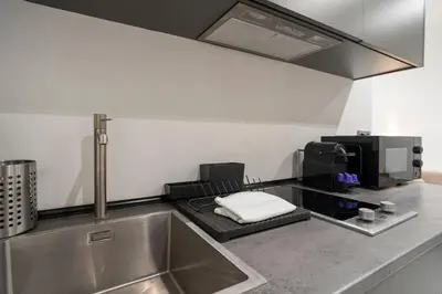 a kitchen with a sink and a microwave at VLC HOST - Bellvis in Valencia