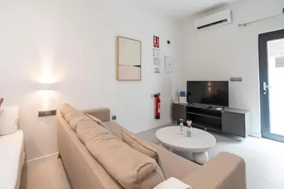 a living room with a couch and a tv at VLC HOST - Bellvis in Valencia