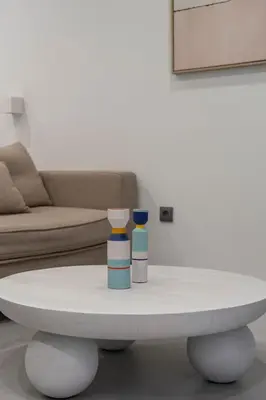 a coffee table with two bottles on top of it at VLC HOST - Bellvis in Valencia